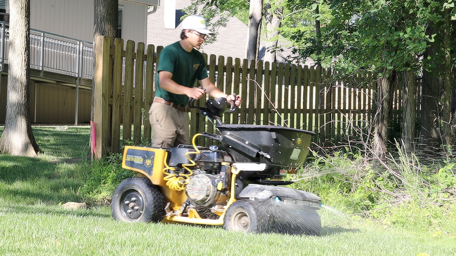 Precision Grounds team member operating a Stinger lawn applicator