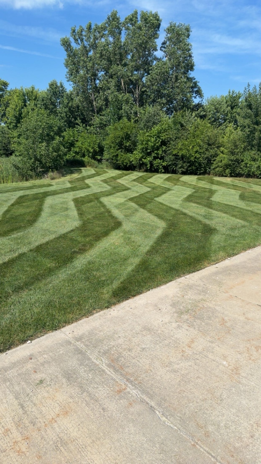 Finished green lawn with distinctive mowing stripes